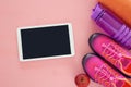 fitness concept with bottle of water, towel, tablet devise and woman pink sport footwear over colorful background Royalty Free Stock Photo