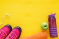 fitness concept with bottle of water, towel and woman pink sport footwear over colorful background Royalty Free Stock Photo