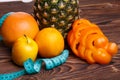 Fitness concept with pineapple, oranges, apples, sweet pepper and measuring tape