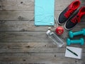 Sneakers dumbbells bottle of water apple and measure tape und Royalty Free Stock Photo