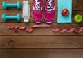 Sneakers dumbbells bottle of water apple and measure tape Royalty Free Stock Photo