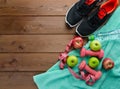 Sneakers dumbbells bottle of water apple and measure tape Royalty Free Stock Photo