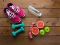 Sneakers dumbbells bottle of water apple and measure tape Royalty Free Stock Photo