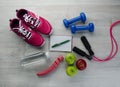 Sneakers dumbbells bottle of water apple and measure tape Royalty Free Stock Photo