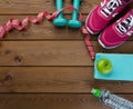 Sneakers dumbbells bottle of water apple and measure tape Royalty Free Stock Photo