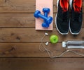 Sneakers dumbbells bottle of water and apple Royalty Free Stock Photo