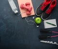 Sneakers dumbbells headphones bottle of water apple and skipping rope Royalty Free Stock Photo