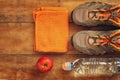 Fitness concept with sport footwear over wooden background. top view image