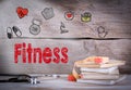 Fitness Concept. Stack of books and a stethoscope on a wooden background Royalty Free Stock Photo