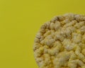 Fitness corn crisps on yellow background close up