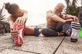 Fitness couple doing stretching exercise outdoor - Happy athletes making workout session at sunset outside Royalty Free Stock Photo