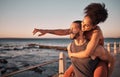 Fitness, couple and piggyback for beach sunset, travel or fun holiday journey together in the outdoors. Happy man and Royalty Free Stock Photo