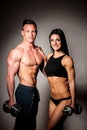 Fitness couple poses in studio - fit man and woman