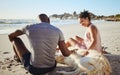 Fitness couple relax with dog at beach, sand and ocean after summer workout, free time and fun in sunshine together Royalty Free Stock Photo