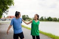 A fitness couple stretches in the park. In the morning, a young man and a young woman exercise together. After jogging, a couple Royalty Free Stock Photo