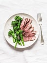 Fitness diet healthy lunch - grilled beef steak and boiled broccoli on a light background, top view