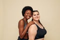 Fitness. Different Ethnicity Women Portrait. Caucasian And African Models In Fitness Clothes Posing On Beige Background.