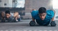 Fitness, dumbbell weights and men doing a push up exercise for strength, health and wellness in a gym. Sports Royalty Free Stock Photo