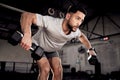 Fitness, dumbbells and man exercise at gym for training workout with focus. Serious male athlete or bodybuilder with