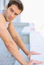 Fitness, earphones and young man athlete by a wall for running listening to music, playlist or album. Sports, workout Royalty Free Stock Photo