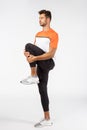 Fitness, endurance and workout concept. Motivated, focused good-looking young male athlete in sportswear, raise on foot