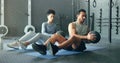 Fitness, energy and friends on gym floor with weight ball for training, power and exercise together. Cross, workout and Royalty Free Stock Photo