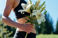 fitness enthusiast offering a bunch of lilies postworkout