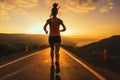 Fitness enthusiast, a woman runs a sunset trail, preparing for a marathon