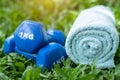 Fitness equipment - Dumbbells, towels placed on the grass The concept of healthy love through exercise Breathe in the natural