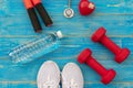 Fitness equipment gym workout and fresh water with heart and medical stethoscope on the blue background, top view and copy space Royalty Free Stock Photo