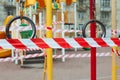Fitness equipment and playground closed for quarantine Covid-19. Playground is blocked by red warning tape Royalty Free Stock Photo
