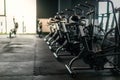 Fitness Equipment. Stationary Bikes Standing In A Row At Empty Gym