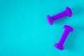 Fitness equipment with womens purple weights/ dumbbells isolated on a light sky blue background with copyspace Royalty Free Stock Photo