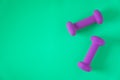 Fitness equipment with womens purple weights/ dumbbells isolated on a teal green background with copyspace Royalty Free Stock Photo