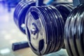 Fitness exercise equipment barbells in the sports gym. Black barbell plates in sport fittness center. Close-up Royalty Free Stock Photo