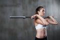 Fitness, exercise and woman with barbell at gym for bodybuilding, strength or endurance on wall background Royalty Free Stock Photo