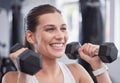 Fitness, exercise and woman with dumbbell in the gym doing workout, training and weight lifting. Health, wellness and Royalty Free Stock Photo