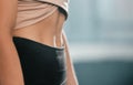 Fitness, exercise and woman with flat stomach at gym for training workout for healthy weight management. Sports, abs and
