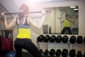 Fitness exercises, a woman performs an exercise bar bench press on the shoulders