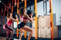 Fitness and exercising concept - two woman with medicine balls training in gym Royalty Free Stock Photo