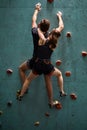 young male and female bouldering on rock climbing wall at indoor gym Royalty Free Stock Photo