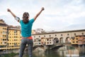 Fitness female rejoicing in front of Ponte Vecchio, Italy