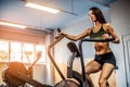 Fitness female using air bike for cardio workout at crossfit gym. Royalty Free Stock Photo