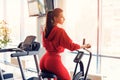 Fitness female using air bike for cardio workout at gym. Royalty Free Stock Photo