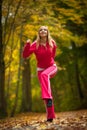 Fitness fit woman blond girl doing exercise in autumnal park. Sport. Royalty Free Stock Photo