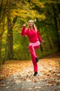 Fitness fit woman blond girl doing exercise in autumnal park. Sport. Royalty Free Stock Photo