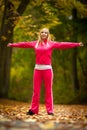 Fitness fit woman blond girl doing exercise in autumnal park. Sport. Royalty Free Stock Photo