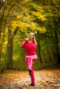 Fitness fit woman blond girl doing exercise in autumnal park. Sport. Royalty Free Stock Photo