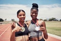 Fitness, friends or black woman with medals for winner, sports victory or wellness race success at sport stadium. Runner
