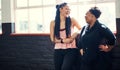 Fitness friends. two cheerful young women having a conversation before a workout session in a gym. Royalty Free Stock Photo